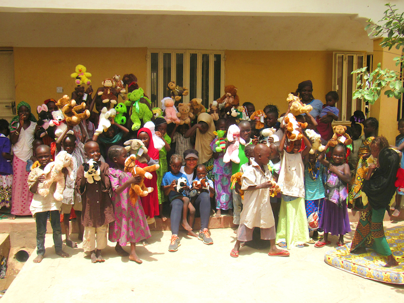 Modupe and rescued children with their new toys site
